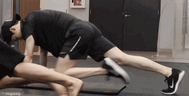 a man is doing a plank with his legs crossed and the word sugary is on the bottom