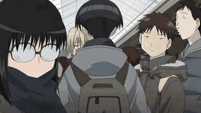 a girl wearing glasses stands in a crowd with a backpack that says e on it