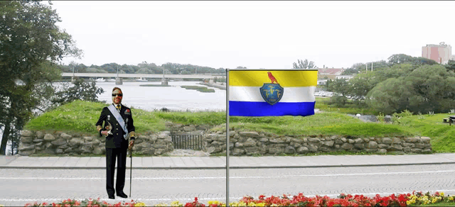 a man standing in front of a flag that says tmc