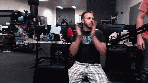 a man sitting in front of a microphone wearing a shirt that says dragon ball z