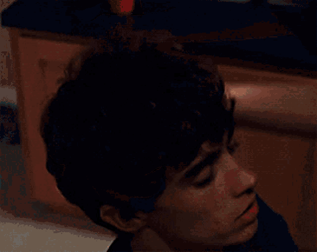 a close up of a person 's head with a hand on it