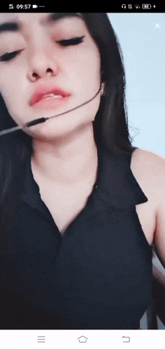 a woman wearing a headset with the time of 9:57