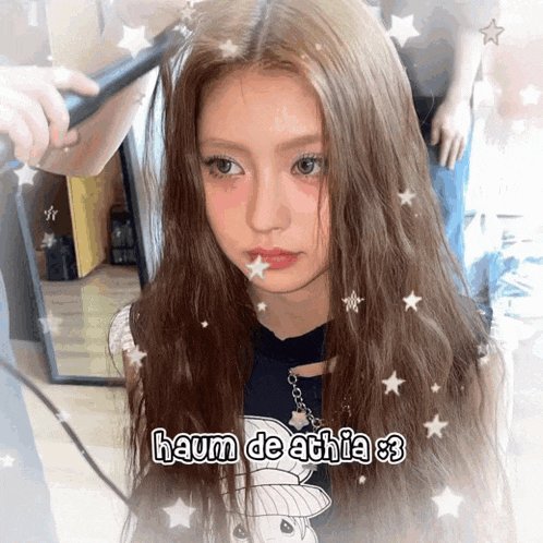 a girl with long hair is getting her hair straightened by someone with the name haum de athia 83