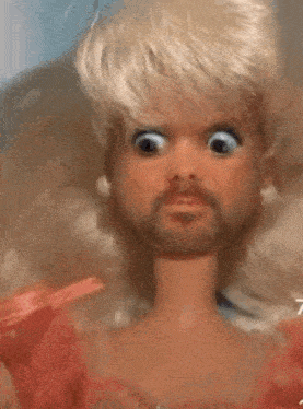 a close up of a doll with a beard