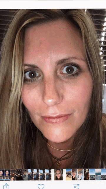 a close up of a woman 's face with a heart in the upper right corner