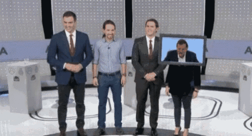 a group of people standing on a stage with the letter a in the background