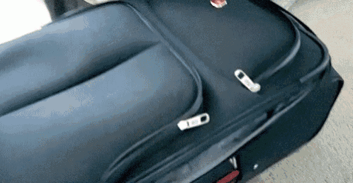 a large black suitcase is sitting on the floor .