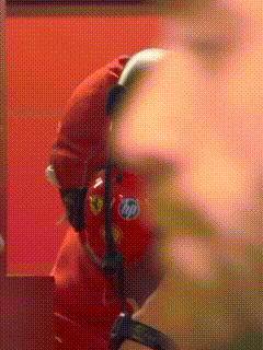 a blurry picture of a man wearing headphones and a red hat