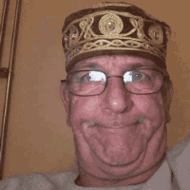 a man wearing glasses and a hat with the letter x on it