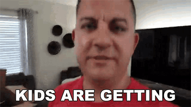 a man in a red shirt says kids are getting in a living room