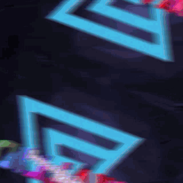 a blurry picture of a blue arrow on a dark background