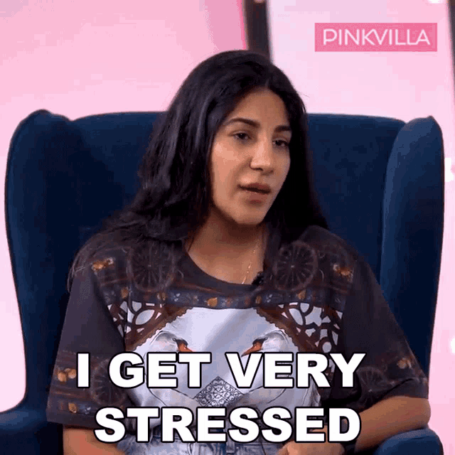 a woman sitting in a chair with the words i get very stressed