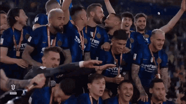 a group of soccer players are celebrating a win