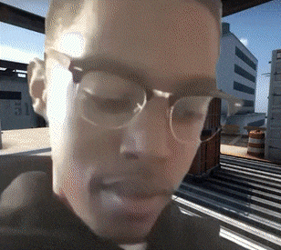 a blurry picture of a man 's face with glasses