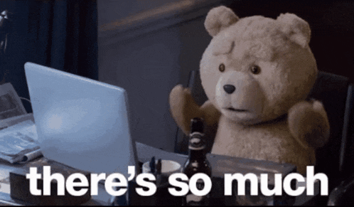 a teddy bear sitting in front of a laptop with the words " there 's so much " on the bottom