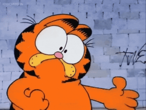 garfield giving a thumbs up in front of a wall with graffiti on it