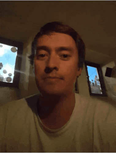 a man is drinking a glass of milk and making a funny face