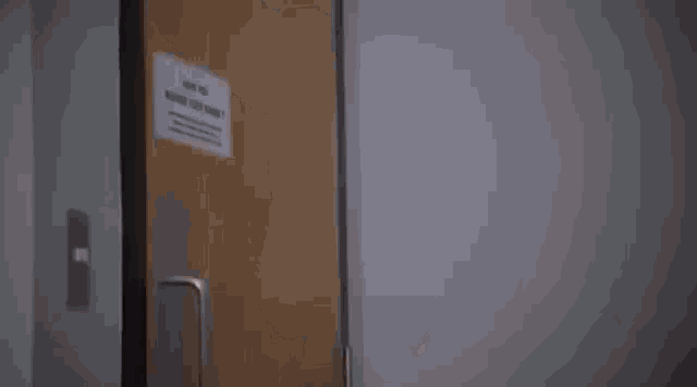 a person is standing in a doorway in a room .