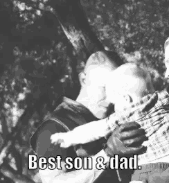 a black and white photo of a man holding a baby and the caption best son and dad