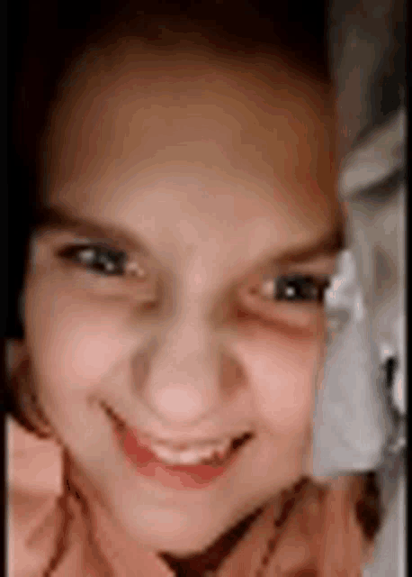 a close up of a young girl 's face with a smile on her face .