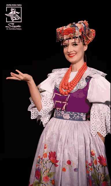 a woman wearing a purple and white dress and a red necklace with the word slack on the bottom