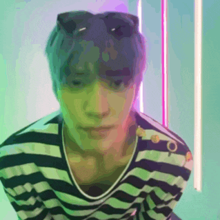 a man wearing a striped shirt and sunglasses is looking at the camera