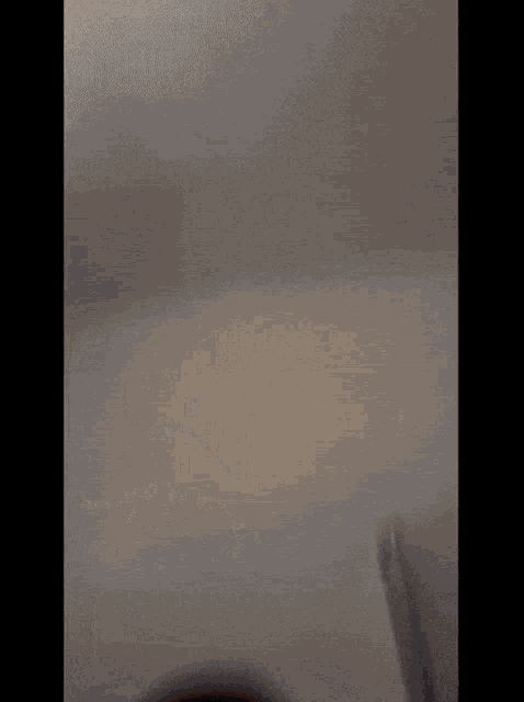 a blurry picture of a man wearing a black hat