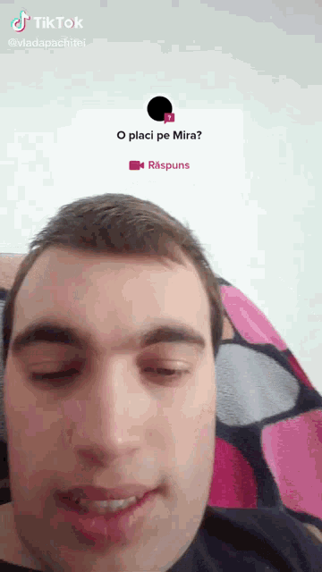 a man laying on a couch with a tiktok sticker on his head