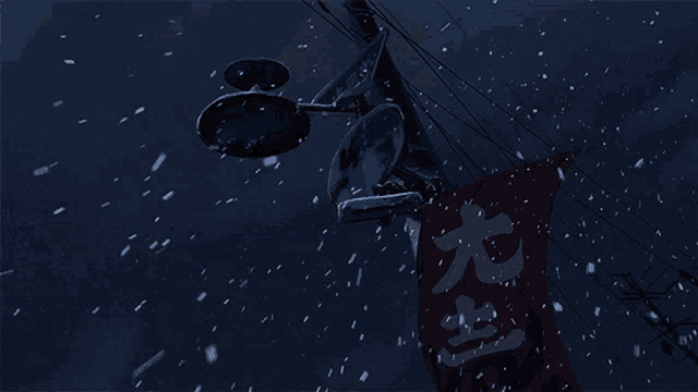 a red sign with chinese writing on it is hanging from a pole in the snow