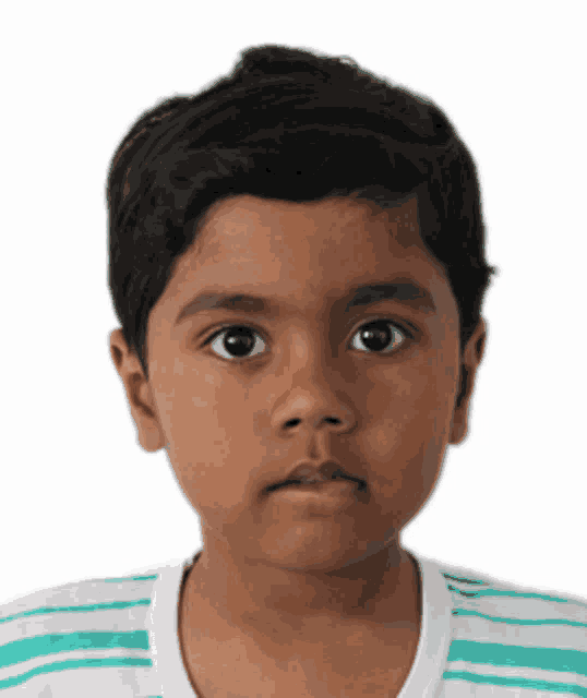 a young boy wearing a green and white striped shirt is looking at the camera