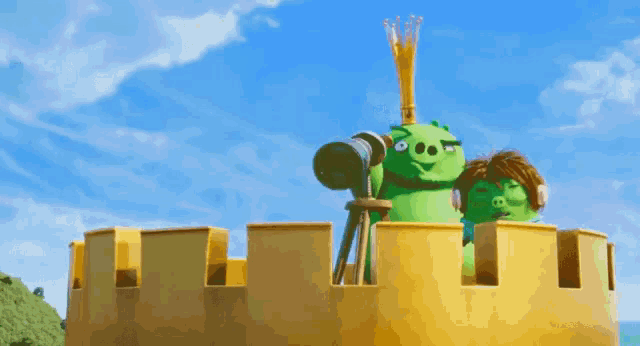 a green cartoon character looking through a telescope on top of a castle