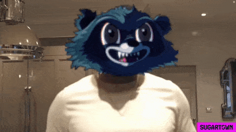 a man in a white shirt has a raccoon mask on his head