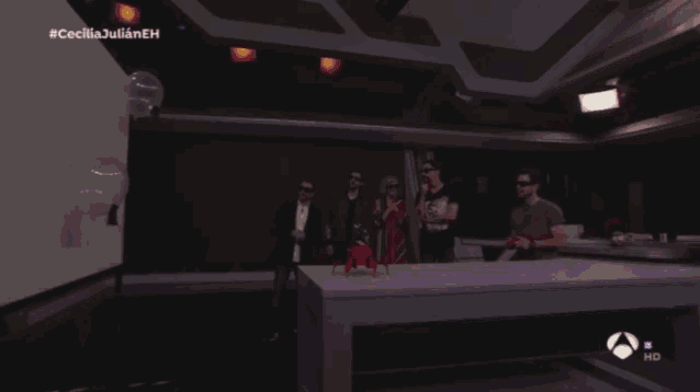 a group of people standing around a table with a sign that says repe hd