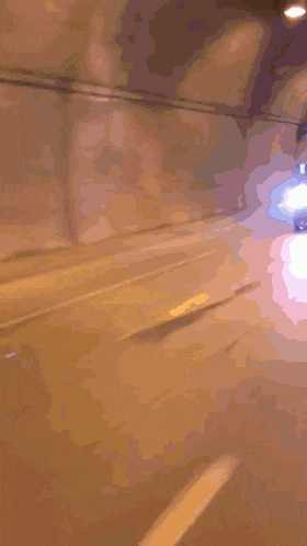 a blurred image of a car driving down a road at night