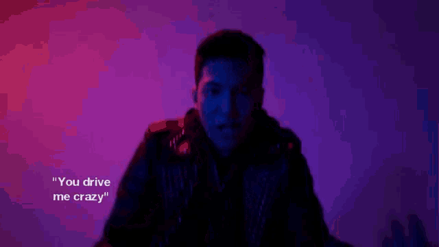 a man is standing in front of a purple wall with his arms outstretched and says `` but i stick with you '' .