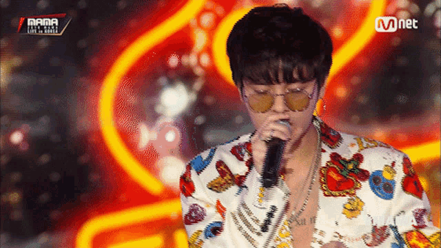 a man singing into a microphone with the word mama on the bottom