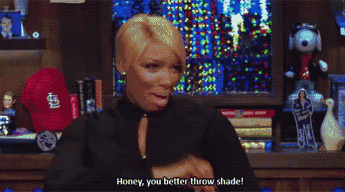 a woman says honey you better throw shade while blowing a kiss