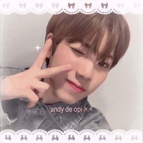 a young man making a peace sign with the words andy de opi written below him