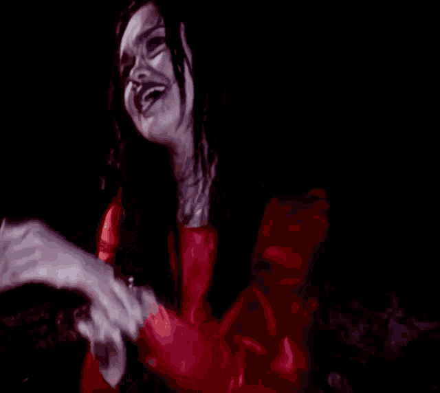 a woman in a red dress is making a funny face