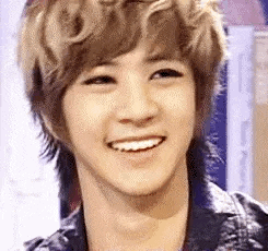 a close up of a young man 's face with a smile on his face .