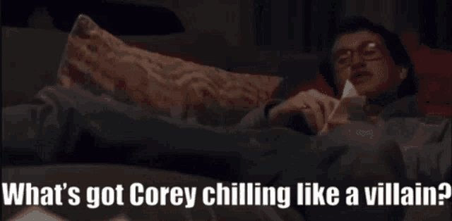 a man laying on a couch with the words " what 's got corey chilling like a villain " written below him