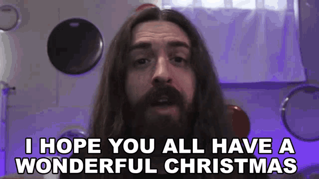 a man with long hair and a beard saying i hope you all have a wonderful christmas