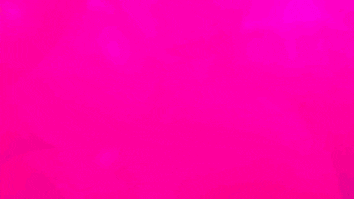 a large statue of a woman 's face is surrounded by pink balls
