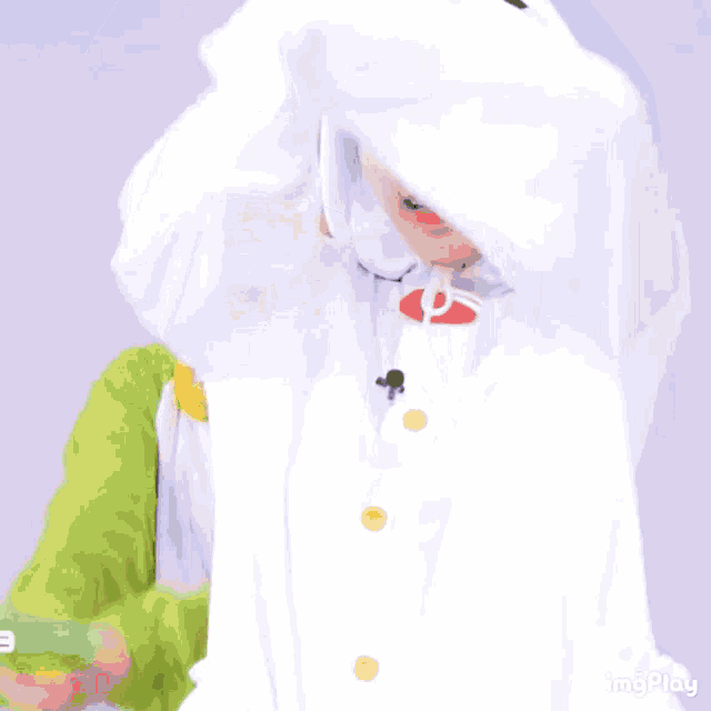 a person in a green and white costume is holding a water gun