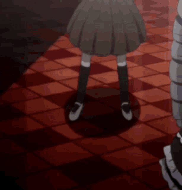 a girl is kneeling down on a checkered floor and covering her face with her hands