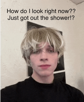 a young man wearing a wig is asking how do i look right now ? just got out the shower !