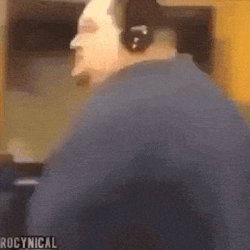 a blurry picture of a man wearing headphones with the words rocynical written on the bottom