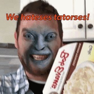 a man with a blue face is holding a box of bob 's brownie popcorn
