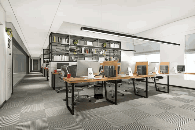a row of cubicles in an office with computer monitors on them