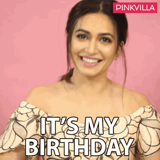 a woman says it 's my birthday in front of a pink wall